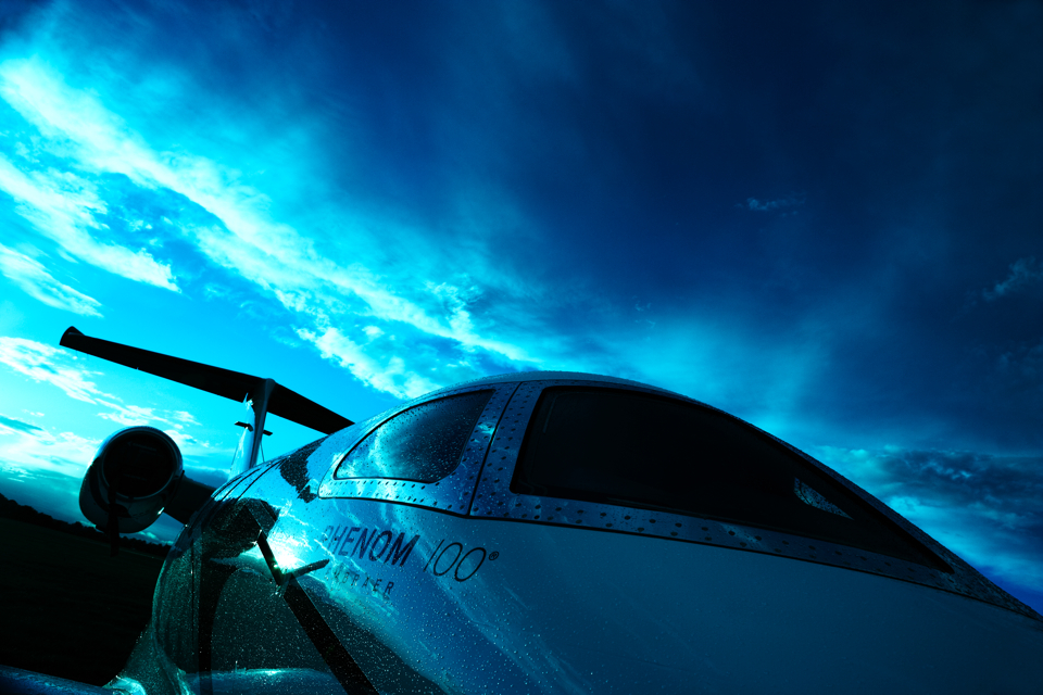 Embraer Phenom 100 business jet in dramatic light.